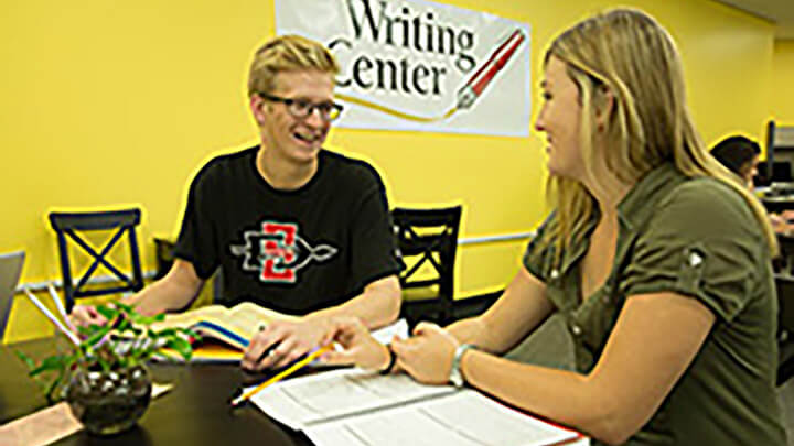 The Writing Center tutor helps a student